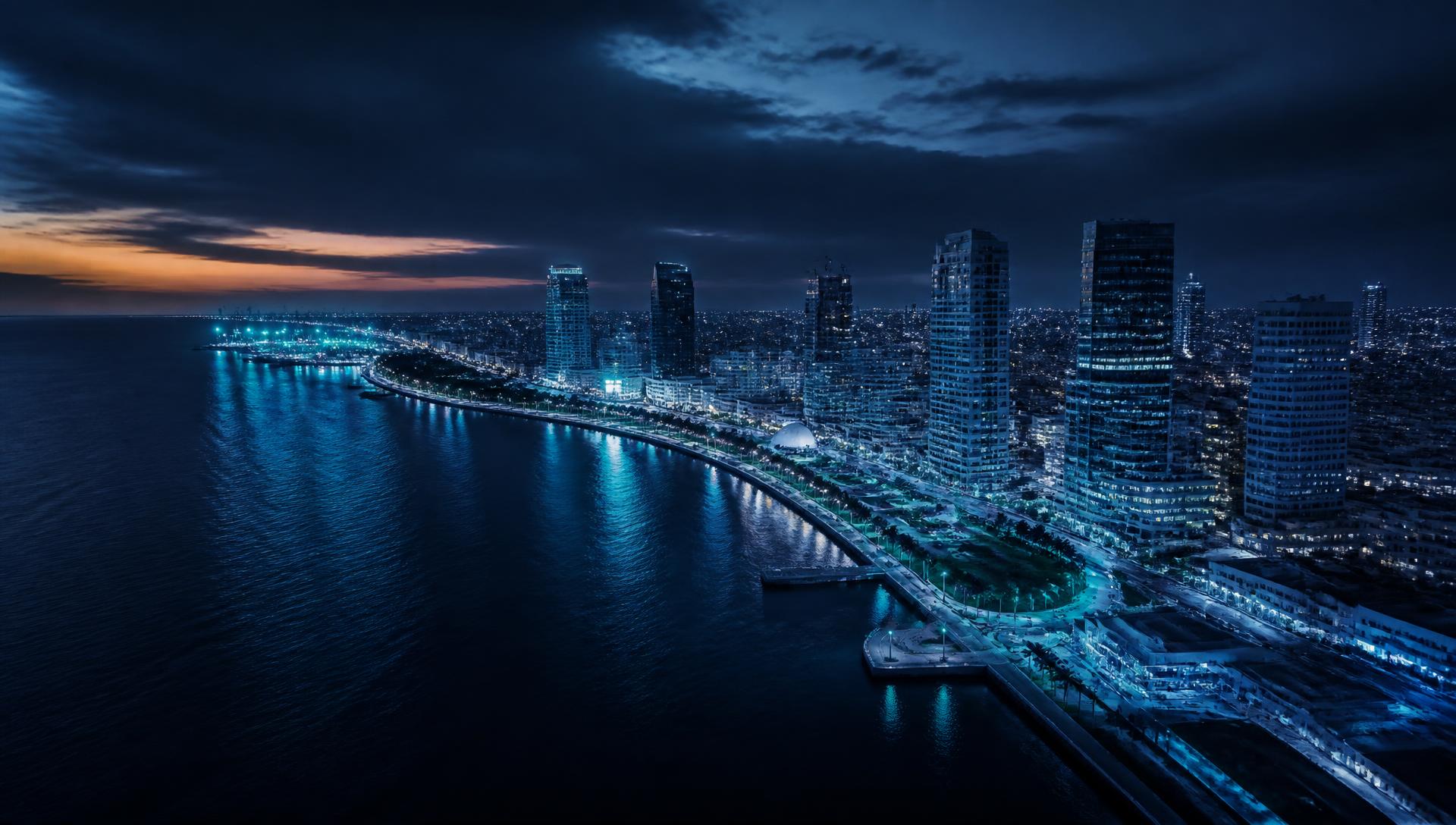 Baía de Luanda ao anoitecer, vista aérea da marginal e dos edifícios da cidade